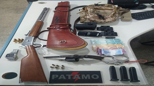 Uma guarnição do 7º Batalhão da Polícia Militar – 7º BPM, de Ariquemes, recuperou no último domingo,10, um revólver calibre .357, com seis munições intactas e uma carabina Rossi calibre .38 com oito munições intactas, um coldre de couro, uma bolsa com três carregadores de pistola calibre 9mm. Durante patrulhamento pelo bairro Jardim Felicidade, a guarnição visualizou uma mulher visivelmente abalada pedindo socorro. Em contato com os policias ela informou que teria discutido com seu parceiro e que sabia da localidade dele, porém tinha medo, pois segundo ela, onde ele estava, o seu irmão estaria na posse de uma arma de fogo. Com base nas informações os policias tentou localizar o parceiro e o irmão da referida vítima, diante da fragrância do suposto crime de violência doméstica e da possível arma de fogo, fora realizado buscas nas dependências e na residência foi visualizado e surpreendido o irmão da mulher, sendo este abordado. Na revista pessoal foi encontrado um revólver calibre .357 com seis munições intactas ponta oca, ele assumiu a propriedade da arma, todavia, passou a fazer ameaças para vítima, afirmando que teria entregado-o. A Vítima ainda temendo por sua vida afirmou que em outra residência havia mais armas ligadas ao grupo que seu irmão fazia parte. Em uma ação contínua foram feitas buscas na residência do seu irmão, porém nesta residência não foi localizado nada de ilítico, no entanto a arma foi encontrada escondida em um dos quartos de uma residência vizinha a do suspeito. Era uma carabina Rossi calibre .38, com oito munições intactas, um coldre em couro, uma bolsa contendo três carregadores de pistola calibre .9mm, objetos referentes a um furto no mês passado. Diante da situação a proprietária da residência e seu parceiro foram questionados sobre a arma de fogo em sua propriedade bem como os já citados matérias encontrados no quarto do casal, porem alegaram desconhecer os objetos encontrados. Diante dos fatos os três suspeitos foram conduzidos para a Unisp para as devidas providencias. Texto: P-5 do 7º BPM / PVSA Letícia Fonte e fotos: Boletim de Ocorrência